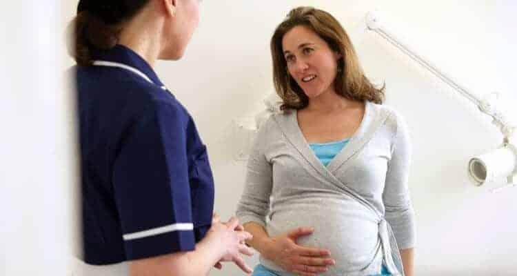 a lactation nurse talking to a pregnant patient