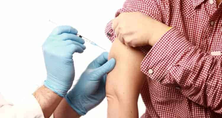 a nurse giving a patient a flu shot