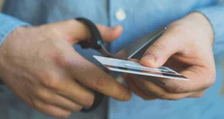 a nurse cutting up their credit card