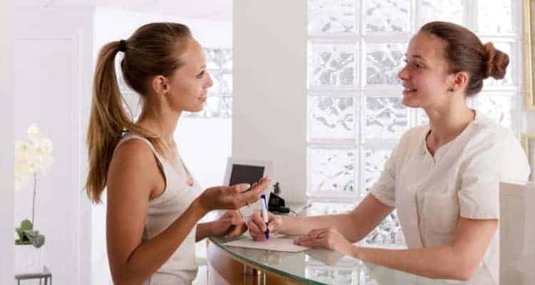 a clinic nurse checking in a patient