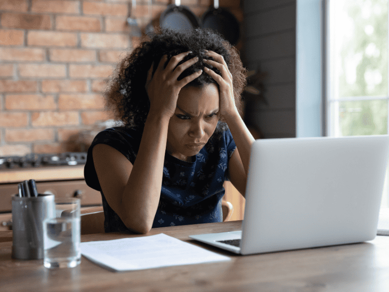 woman looking at computer sad