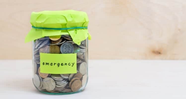 a jar full of money with the word emergency written on the outside