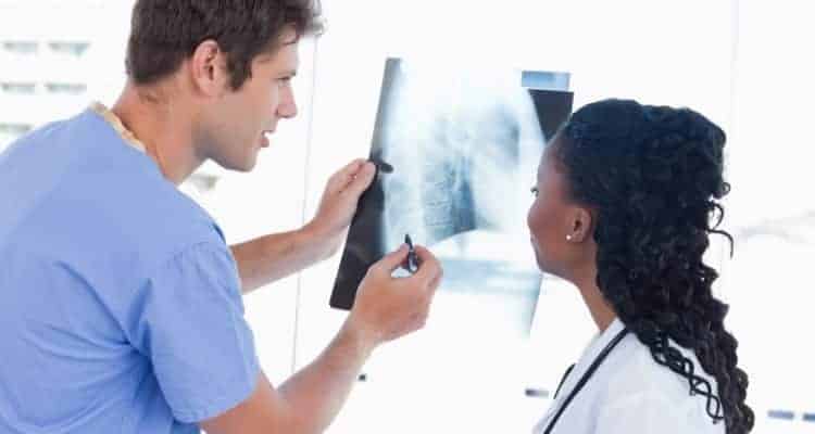 physician assistant and nurse looking at x-ray