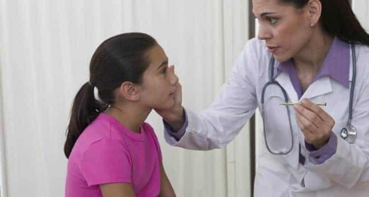 school nurse examining a student