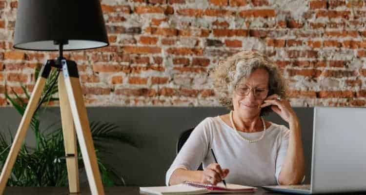 older woman studying for nursing school