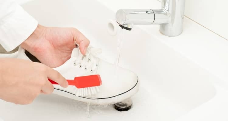 a nurse cleaning her shoe