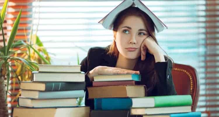 a nursing student with a lot of textbooks