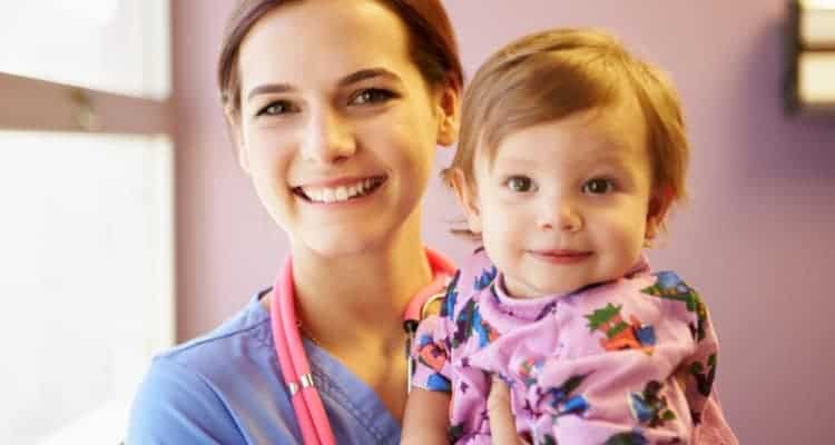 a pediatric nurse with a child