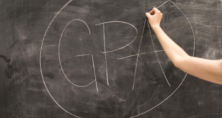 nursing student writing gpa on chalkboard