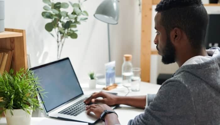 college student researching nursing schools on computer