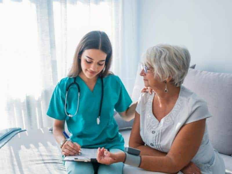 a nurse taking patient blood pressure 