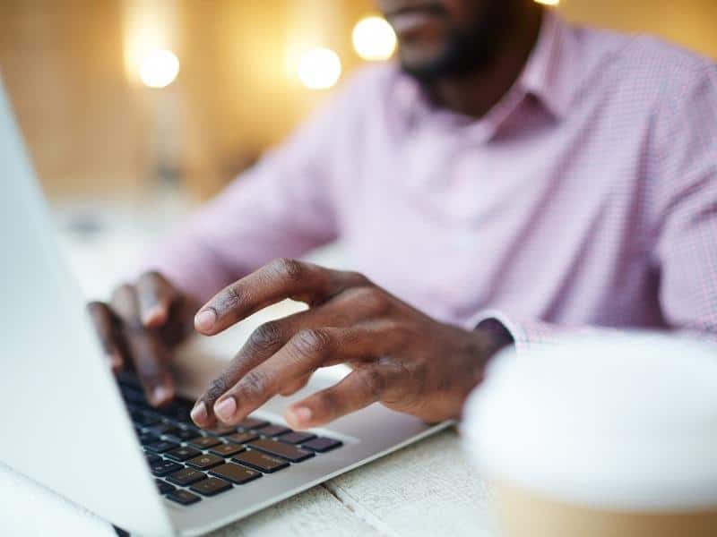 student typing on computer