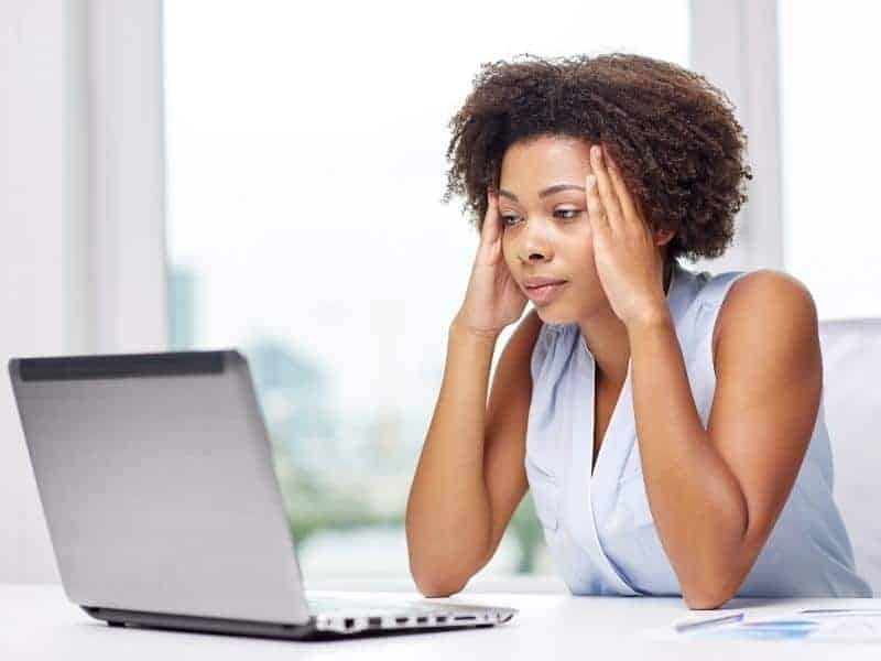 woman looking at computer sad