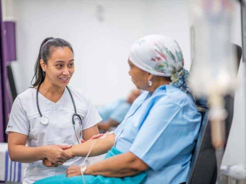 nurse checking her cancer patient