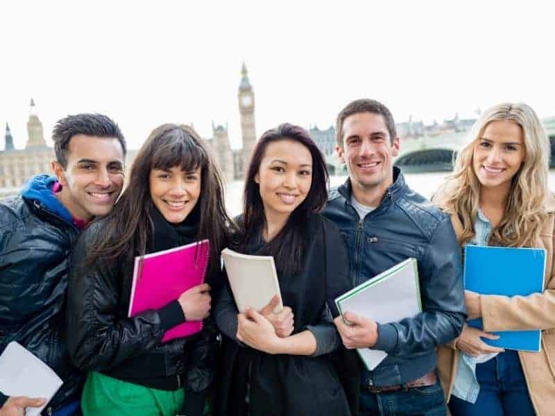 students abroad carrying notebooks