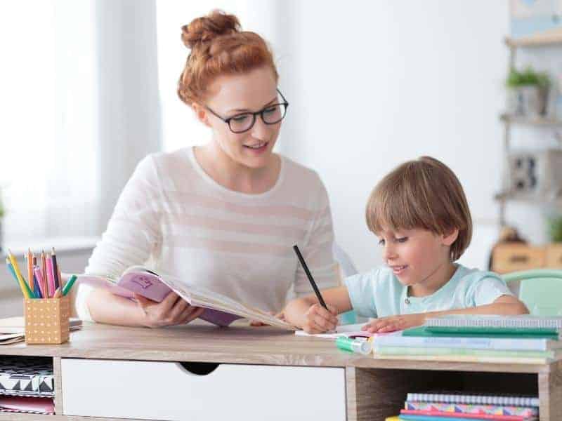 woman tutoring a kid