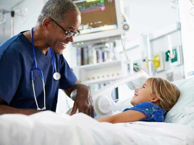 Young girl talking to male nurse