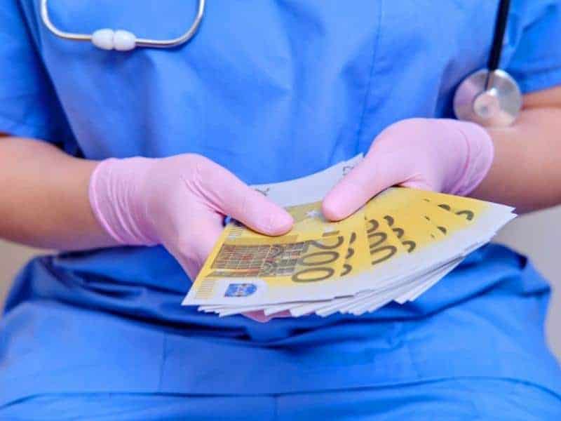 nurse holding euro money 