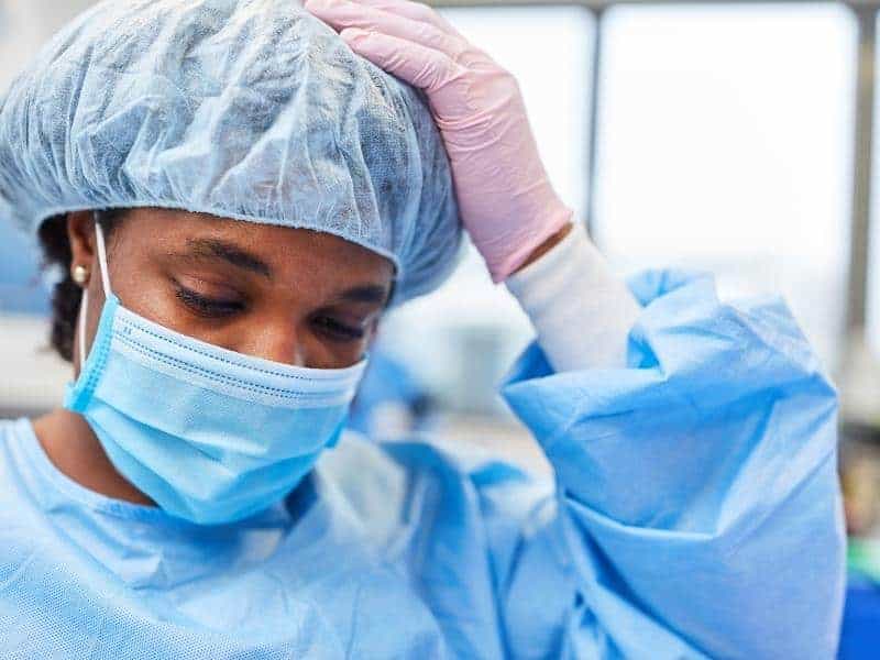 nurse touching her head