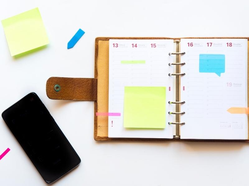 Article Image - Planner, Smartphone, and Sticky Notes on a Table