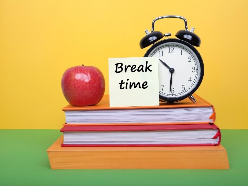 alarm clock on top of books