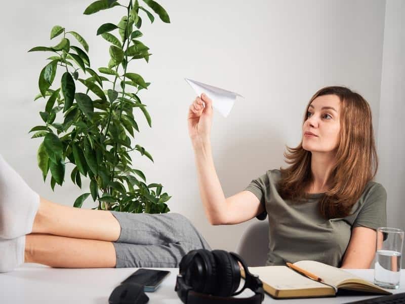 woman playing paper plane