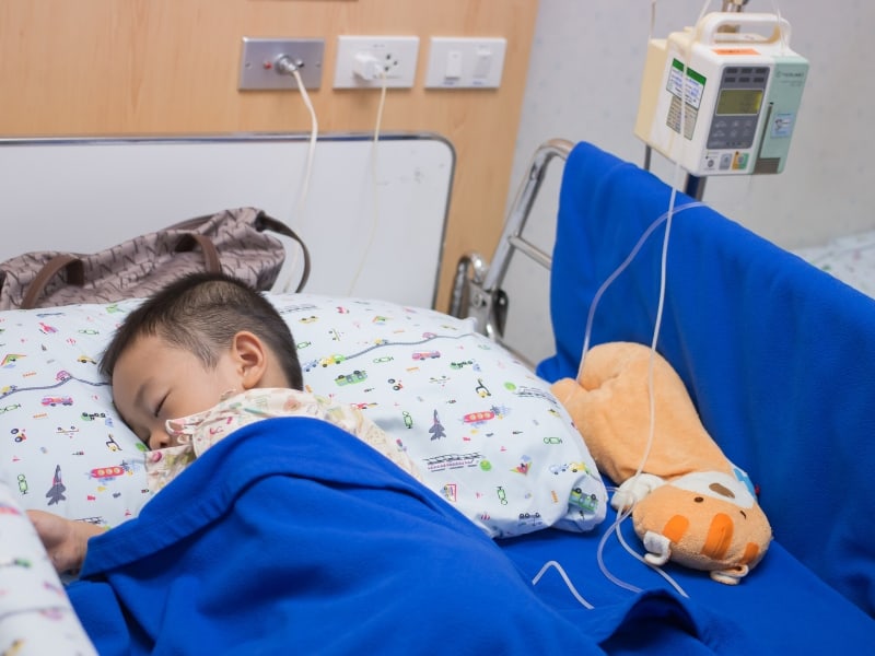 child sleeping in hospital bed