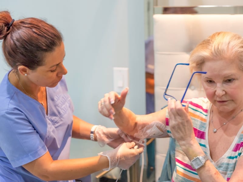 a nurse taking care of a patient's peripherally inserted central catheter