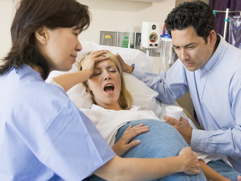 nurse assisting pregrant woman